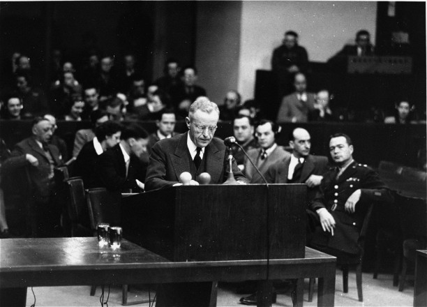 U.S. Deputy Chief of Counsel Charles M. LaFollette at the podium during the Justice Case. Behind him is the prosecution team., n.d. Source: https://collections.ushmm.org/search/catalog/pa1058535